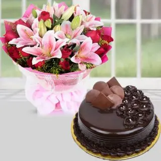 Bunch of pink lilies with red roses with chocolate truffle cake 