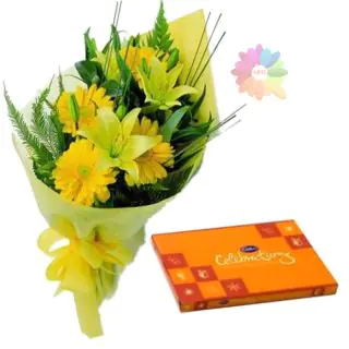 Bunch of yellow lilies with yellow gerberas with box of celebrations