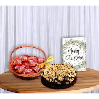Cashew plum cake with basket of kitkat chocolates with greeting card
