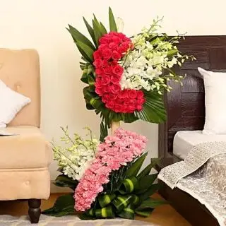 Designer 4 feet height bouquet of 50 pink carnations, 50 red roses, with 20 white orchids 