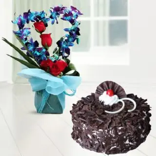 Exclusive heart shape vase arrangement with blue orchids and red roses with black forest cool cake 