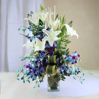 Exclusive Vase arrangement of Blue Orchids with  white lilies 