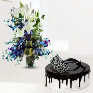 Exclusive vase arrangement of blue orchids with white lilies with choco vanilla cool cake 