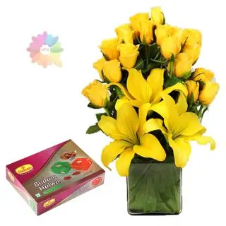 Exotic arrangement of yellow lilies with yellow roses with  Half kg badam halwa from haldiram