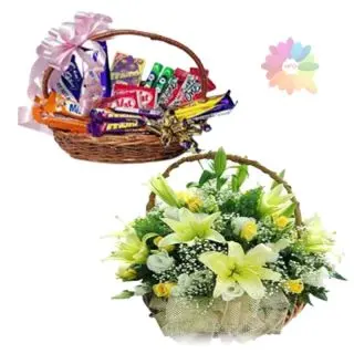 Exotic basket arrangement of lilies and roses with basket of assorted chocolates