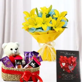 Exotic hand bouquet of 5 yellow asiatic lilies, basket of assorted chocolates with teddy bear sitting in it, with anniversary greeting card