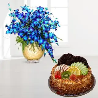 exotic vase arrangement of 20 blue orchids with premium quality butterscotch fruit cake 