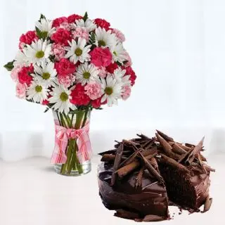 Exotic vase arrangement of daisy with carnations with half kg chocolate truffle cake 
