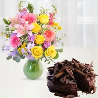 Exotic vase arrangement of roses, lilies and carnations with chocolate truffle cake