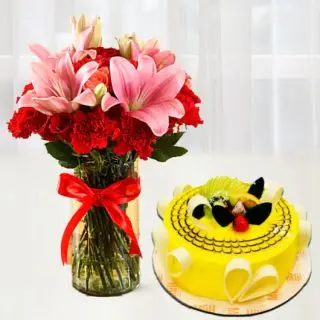 Exotic vase arrangement of pink lilies with red carnations with pineapple premium quality cake 