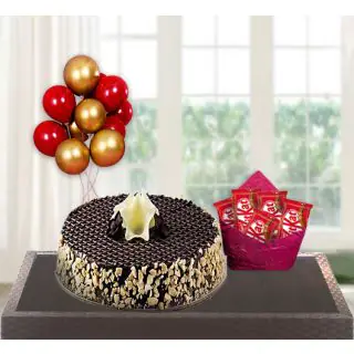 chocolate cashew cake with pack of 5 kitkat with bunch of 5 blown balloons 