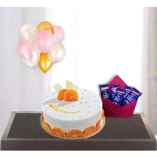  orange cool cake with pack of 5 dairy milk chocolates with bunch of 5 blown balloons 