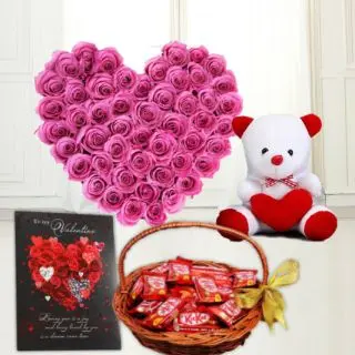 Heart shape arrangement of 30 pink roses, basket of kit kat chocolates, greeting card with 6 inch teddy bear 