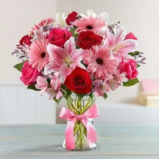 Premium Vase arrangement of pink gerberas, pink lilies with red roses 
