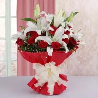 bunch of white lilies with red carnations
