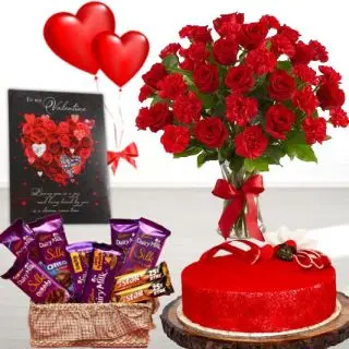 Red roses with red carnations in glass vase,basket of dairy milk silk&5star chocolate,half kg red velvet cake, greeting card,heart shape balloons 