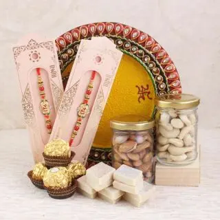 set of 2 rakhis, pooja thali, pack of 5 pcs rocher ferrero chocolates, 200 grams cashew almonds in glass jar with 250 grams kaju katli 