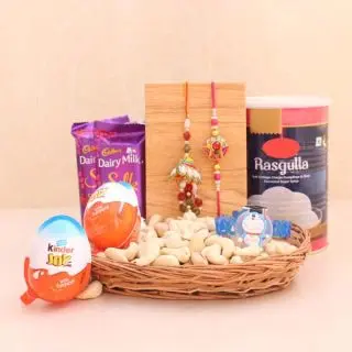set of Bhaiya bhabhi rakhi, 2 kinder joy chocolates, 2 dairy milk silk chocolates ,half kg cashew basket with box of 1 kg haldiram rasgulla 