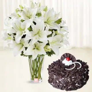 Vase arrangement of 10 white lilies with black forest cake 
