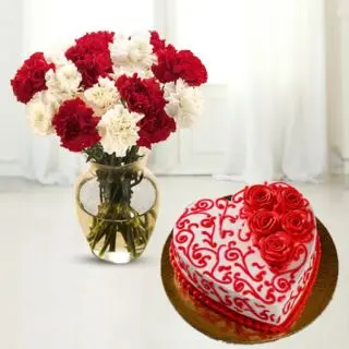 vase arrangement of 12 red and white carnations with heart shape red velvet designer floral theme cake 
