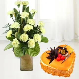 vase arrangement of 15 yellow carnations with mango heart shape cake 