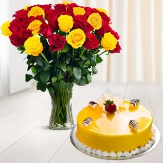 vase arrangement of 20 red and yellow roses with mango cool cake 