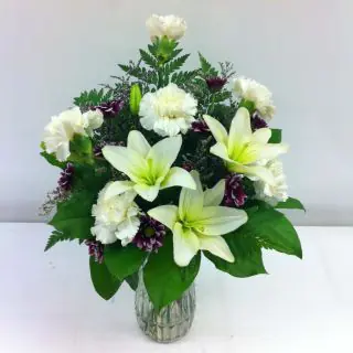 Vase arrangement of 6 white carnations with 2 white lilies 