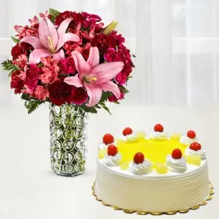 vase arrangement of carnations and lilies with pineapple cake 