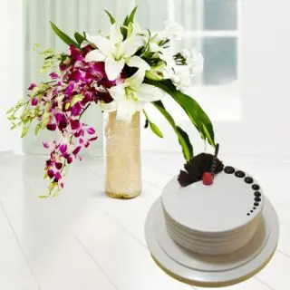 Vase arrangement of lavender orchids with white lilies with vanilla cool cake 