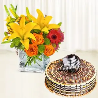 Vase arrangement of lilies , gerberas and roses with butterscotch cool cake 