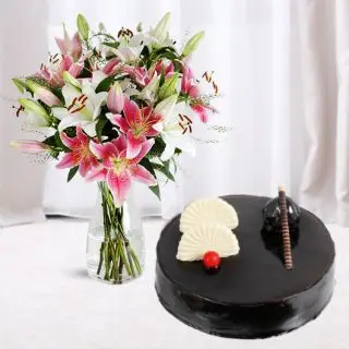 Vase arrangement of mix colour lilies with chocolate cool cake 