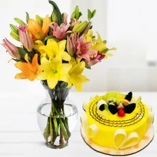 Vase arrangement of mix colour lilies with pineapple premium quality cake 