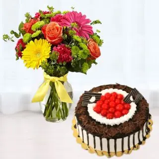 Vase arrangement of mix flowers with black forest premium quality cake 