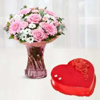 vase arrangement of mix flowers with heart shape strawberry cake 
