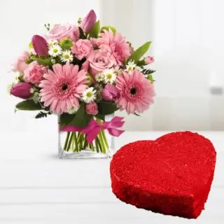 Vase arrangement of pink gerberas with heart shape red velvet cake 