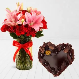 Vase Arrangement of pink lilies red roses with heart shape chocolate cake 