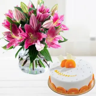 Vase arrangement of pink lilies with orange cool cake 