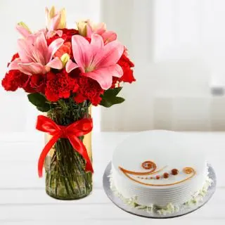 Vase arrangement of pink lilies with red roses with vanilla cool cake 