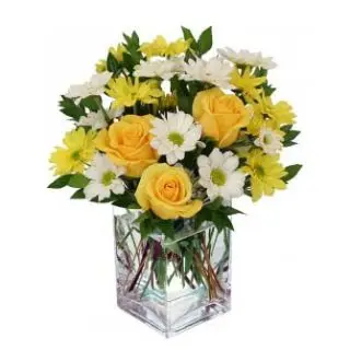 Vase arrangement of white and yellow gerberas with yellow roses 