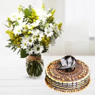 Vase arrangement of white gerberas with butterscotch cool cake 