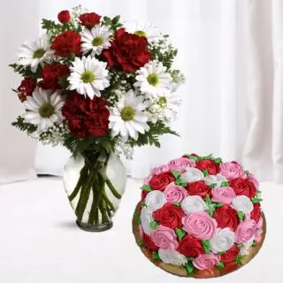 Vase arrangement of white gerberas and red carnations with vanilla floral theme cake 