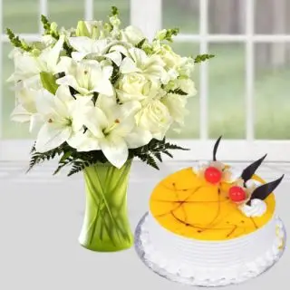 Vase arrangement of white lilies with pineapple cakes