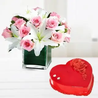 Vase arrangement of white lilies with pink roses with heart shape strawberry cake 
