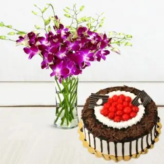 Vase arrangement of 8 purple orchids with premium black forest cake with cherry topping 