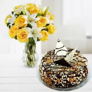 Vase arrangement of lilies and roses with dry fruit cool cake 