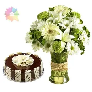 white gerbears with white lilies arranged in glass vase with premium chocolate cake 