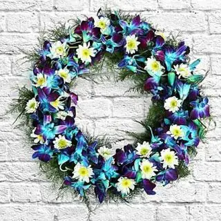 Wreath of blue orchids with white daisy 