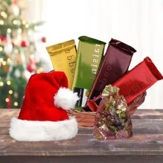 Assorted Home Made Chocolates With 4 Pieces Of Tempatation With Santa Cap Arranged In Basket